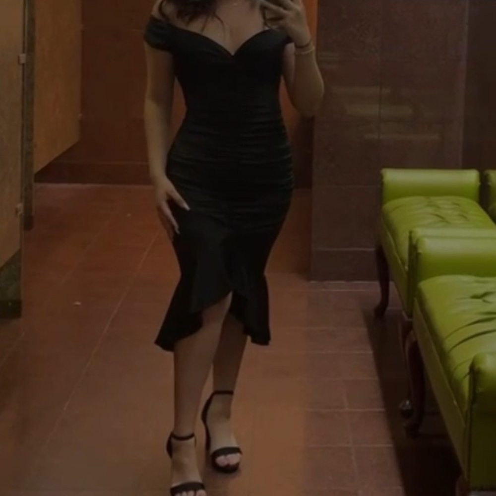Black dress, ruffled from bottom, off the shoulders.